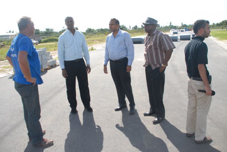 Dtetmar Jakel  (extreme left) explaining to Minister Anthony (center), PS Alfred King (second left), and DPS Steve Ninvalle what work has been completed to date on the synthetic track and what more is left to be done (Photo by Sunil Nelson).