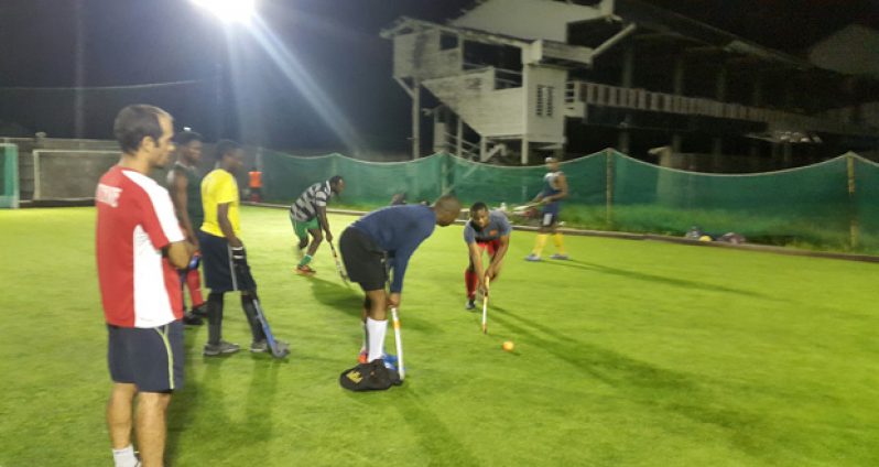 The national men’s Under-21 hockey team in training recently under the watchful eyes of coach Robert Fernandes (extreme left).