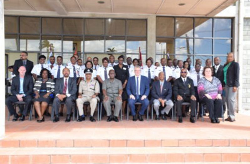 (From left to right) Permanent Secretary to the Ministry of Public Security, Daniella Mc Calmon; Assistant Director Strategic Services CARICOM IMPACS, Earl Harris; Commissioner of Police, Seelall Persaud; Minister of Citizenship, Winston Felix; EU Delegation Representative, Ambassador Jernej Videtic; Assistant Secretary General of the CARICOM Secretariat, Dr. Douglas Slater; Deputy Commisioner of Customs, Excise and Trade Administration, Launcelot Wills and Deputy Commissioner Integrated Regional Tax Offices, Karen Giddings-Chapman, with other officials and the officers who will participate in the training.