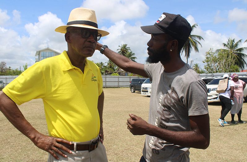 Minister Hamilton interacting with a resident (Ministry of Labour photo)