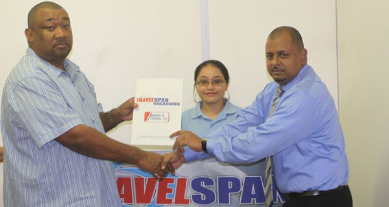 RHTY&SC Secretary/Chief Executive Officer Hilbert Foster (left) accepts the sponsorship cheque from Travelspan’s Station Manager David Goberdhan in the presence of the airline’s Travel Consultant Sophia Fredericks. (Sonell Nelson photo)