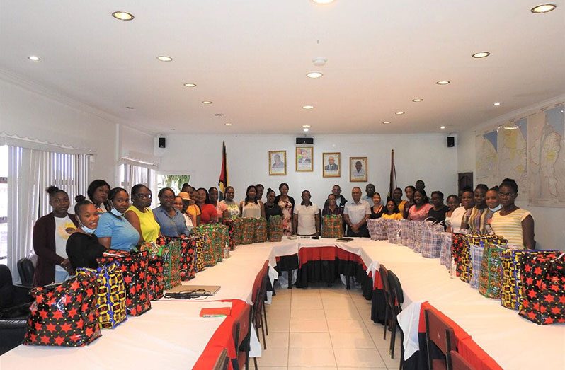 Commissioner of Police (ag), Clifton Hicken (centre) flanked by a number of mothers whom he recognised for their hard work, dedication and sacrifices (GPF photo)