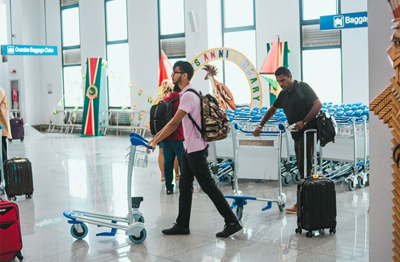 Passengers at CJIA using the Travel 300 trolley