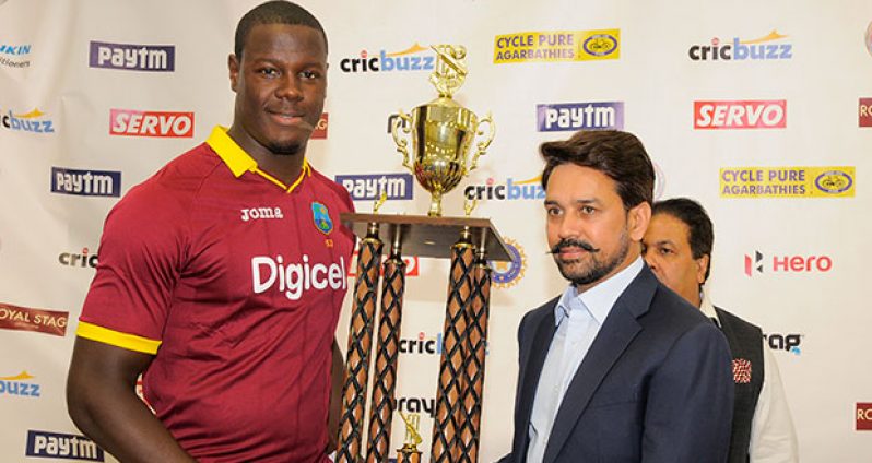 Carlos Brathwaite receives the winning  trophy from BCCI president , Anurag Thakur after the   the 2nd Paytm Twenty20 International between West Indies and India at Central Broward Stadium in Lauderhill, Florida was abandoned yesterday.(Photo by WICB Media/Randy Brooks of Brooks Latouche Photography)