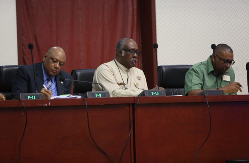 Minister of Natural Resources, Hon. Raphael Trotman, Commissioner of the Guyana Geology and Mines Commission (GGMC), Newell Dennison and Deputy Commissioner of Forests of the Guyana Forestry Commission (GFC), Gavin Agard make notes as they listen to issues raised by the Toshaos at the 13th National Tohaos Council (NTC) Conference at the Arthur Chung Conference Centre (ACCC)