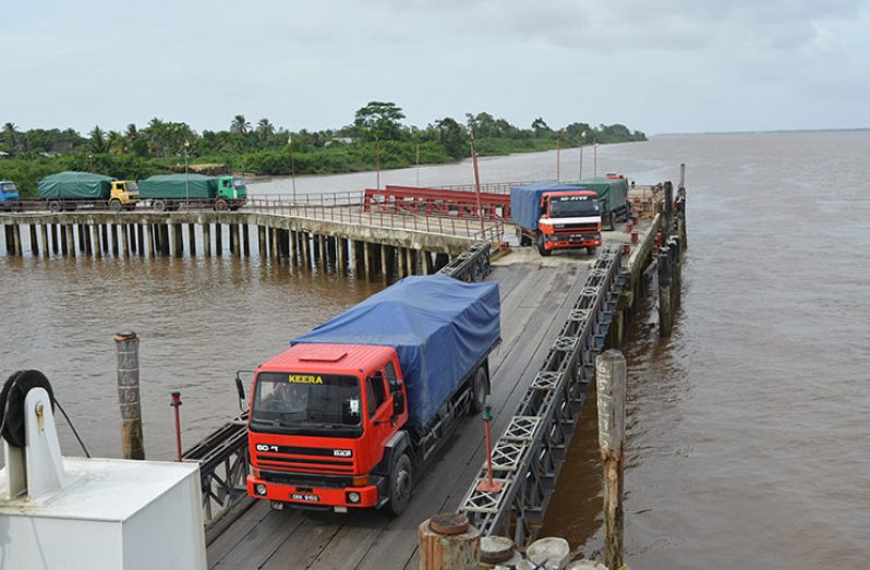 Trucks at the Good Hope Stelling traversing the bridge to a waiting ferry
