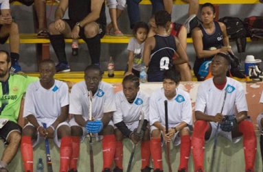 Head coach Robert Fernandes (L) and members of the National U-19 squad during the GT&T Indoor Hockey tournament.