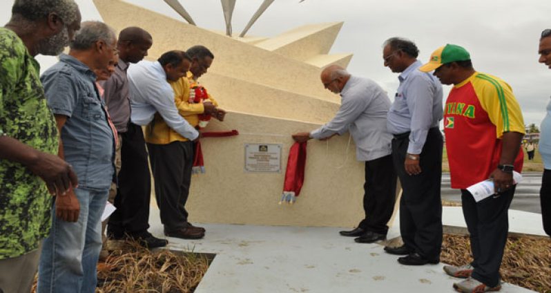 Officially Open! President Donald Ramotar (third from right) unveils the plaque declaring the National Track and Field Centre open. Assisting him is Prime Minister Samuel Hinds (third from left) and Minister of Sport Dr Frank Anthony (second from left). Looking on is Director of Sport Neil Kumar (second from right).