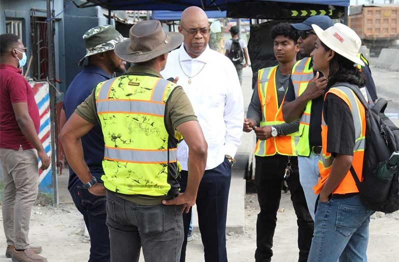 Minister Edghill being briefed on the progress of the relocation process by representatives of various utility companies (Ministry of Public Works photo)