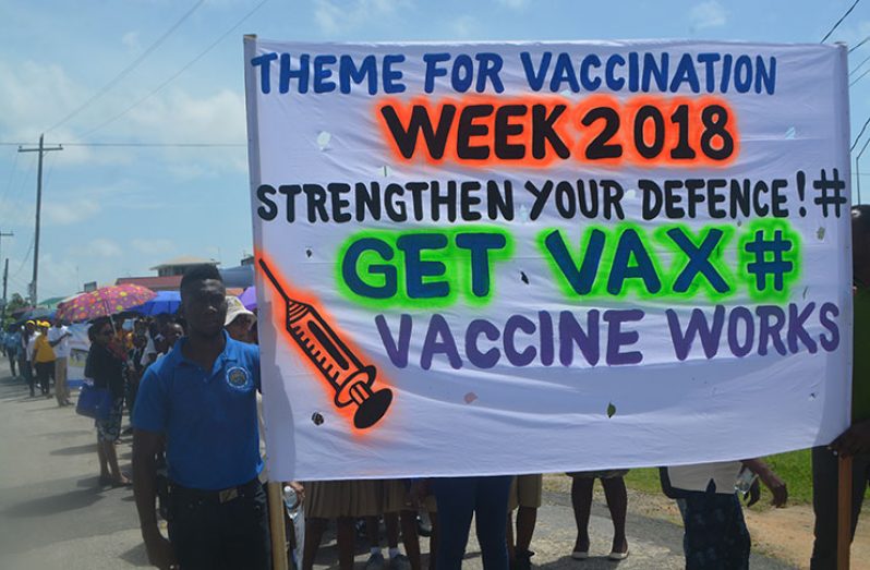 The banner being held high for Vaccination Week