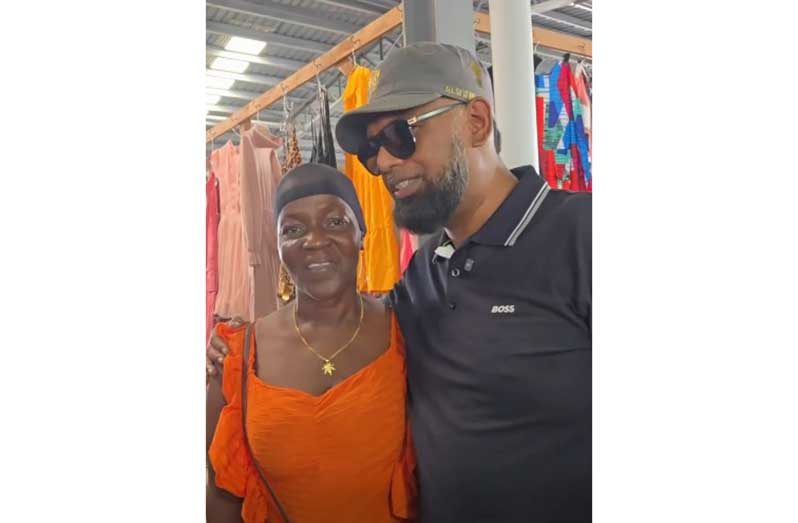 A vendor chats with President, Dr Irfaan Ali about the construction of a small shop at her home