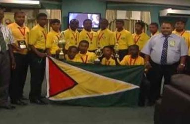 The victorious Under-15 cricketers display their trophies, with GCB president Drubahadur standing at right