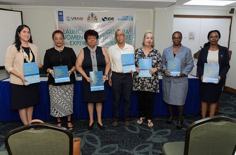 Minister of Social Protection, Amna Ally (third from left); representative from UN Women Multi-Country Office-Caribbean, Alison McLean (second from right) and other stakeholders display copies of the Guyana Women’s Health and Life Experiences Survey Report and Women’s Health and Life Experiences: A Qualitative Research Report on Violence Against Women In Guyana (Delano Williams photo)