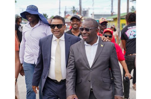 Ministers Indar and McCoy in ‘B’ Field, Sophia, on Thursday where they updated residents on the reconstruction and widening of the community’s access road, which has been in a deplorable state for some time