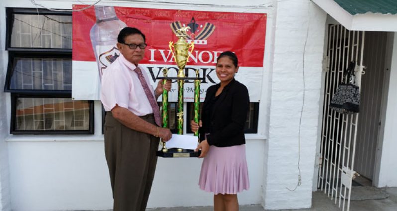 Chairman of the Police Complaints Authority, Cecil Kennard (left), accepts the sponsorship cheque and winner’s trophy from DDL’s Ivanoff Brands manager Maria Munroe.