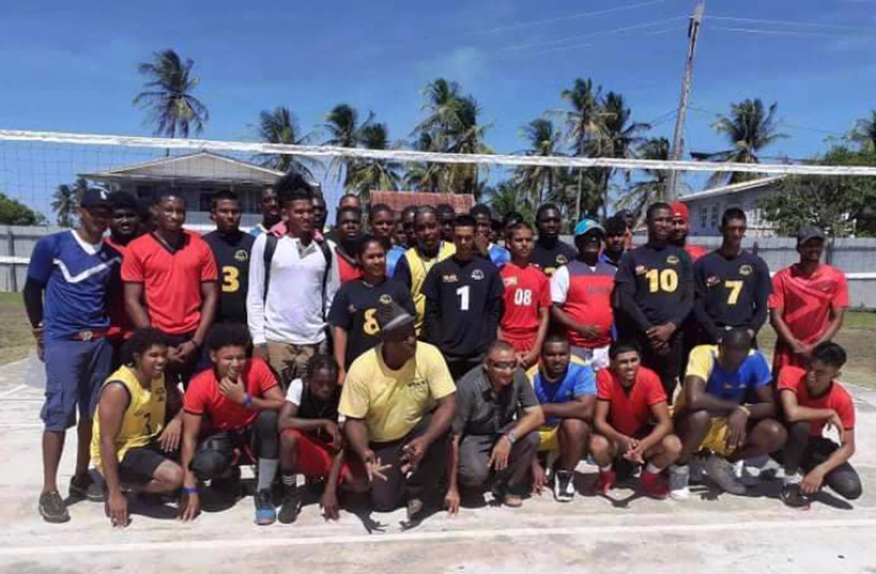 President of the Guyana Volleyball Federation, Levi Nedd (4th from left stooping front row) and Deonarine Balram (5th from left stooping) flocked by the teams following the end of the 7th annual volleyball tourney