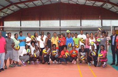 Samaritan Sports Support System representative Robert Sam (left) with the participants of the primary school volleyball clinic. (Photo by Delano Williams)