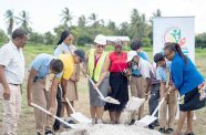 Minister of Education, Priya Manickchand, turns the sod for the Vreed-en-Hoop Secondary School with students and other officials at Crane Region Three