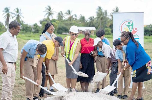 Minister of Education, Priya Manickchand, turns the sod for the Vreed-en-Hoop Secondary School with students and other officials at Crane Region Three