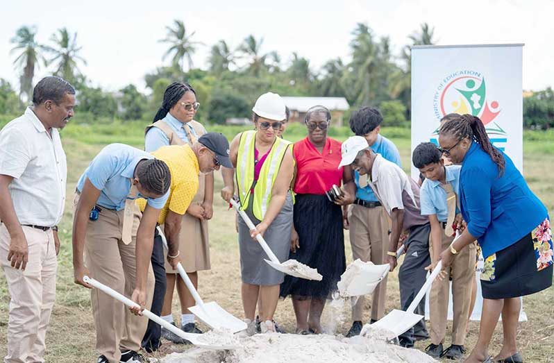 Minister of Education, Priya Manickchand, turns the sod for the Vreed-en-Hoop Secondary School with students and other officials at Crane Region Three