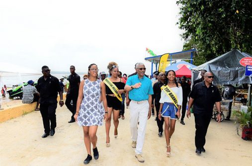 walk President David Granger takes a walk on the beach with his grand-daughter Athena Gaskin and two of the contestants in the Miss Bartica Regatta pageant