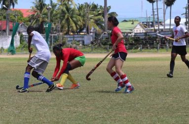 GHB ladies (second and third left) take on their male counterparts during one of their training sessions leading up to the CAC Women’s Hockey Championship, scheduled for Mexico next month.