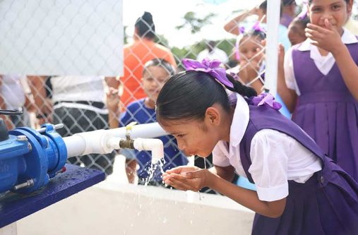 A young child of Falmouth was the first to sample the water from the new multimillion-dollar water supply system (Ministry of Housing and Water photo)