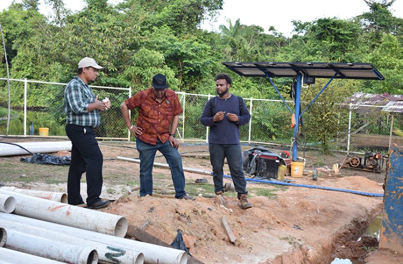 GWI's Managing-Director, Dr. Richard Van-West Charles (centre), Non-revenue water Coordinator Carlos Rodrigues (left) and Hinterland Engineer, Jumal Duncan (right) assessing the progress of ongoing works in Port Kaituma