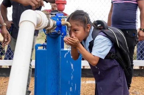 A child drinks water from a newly installed water system