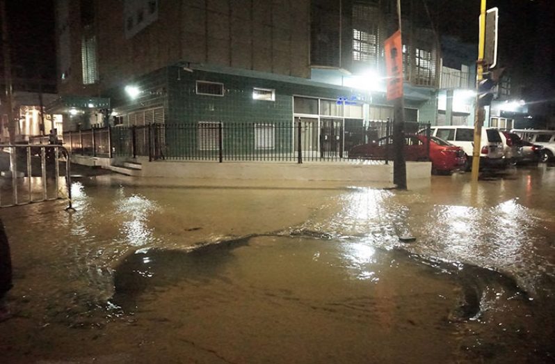 Accumulated water from the breached main near the Bank of Guyana (Carl Croker photo)