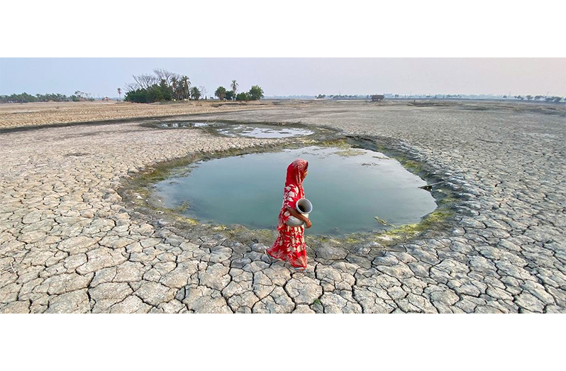A woman collects water in drought-affected Satkhira district in western Bangladesh (DP/Ab Rashid)