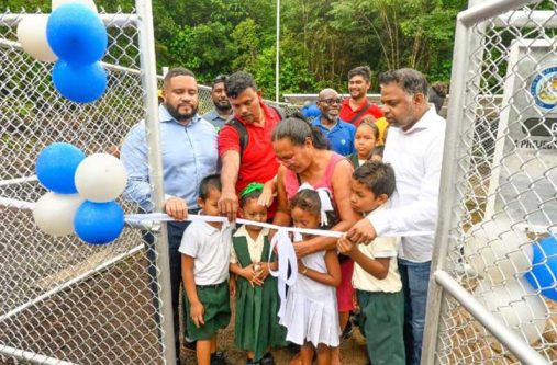 Residents join Minister of Public Utilities and Aviation, Deodat Indar, in commissioning the new water system in Great Falls