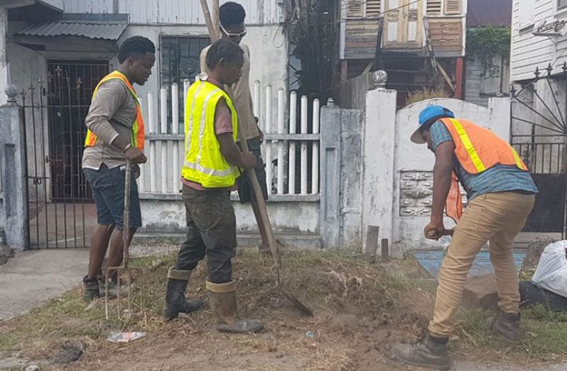 GWI workers disconnecting an illegal connection in Georgetown