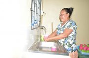 Teacher washes dishes at Nappi Nursery School