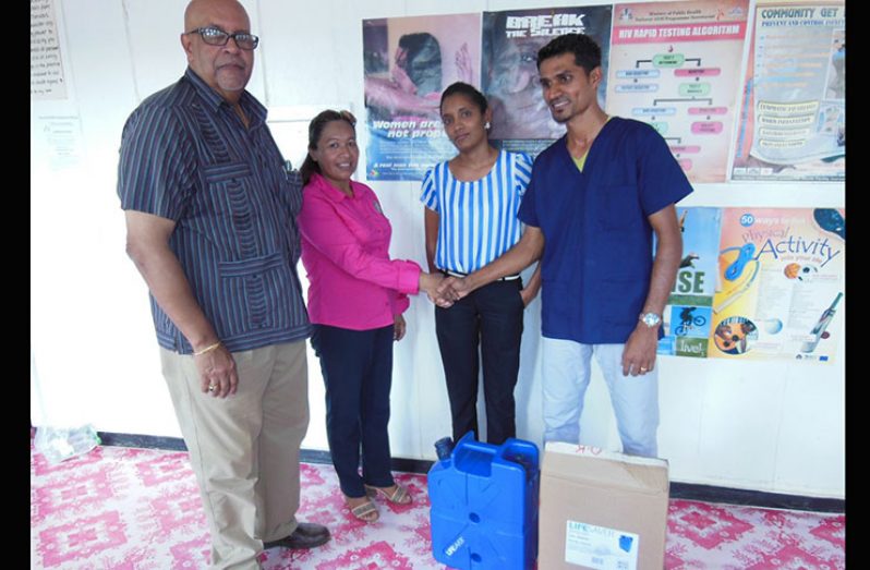 Minister within the Ministry of Communities, Dawn Hastings, presents a filter to Dr. Amitraj Persaud of the Upper Mazaruni, Kamarang District Hospital in the presence of GWI’s Managing Director Dr. Richard Van West-Charles (left) and Dr. Lakshmi Narain (second right)