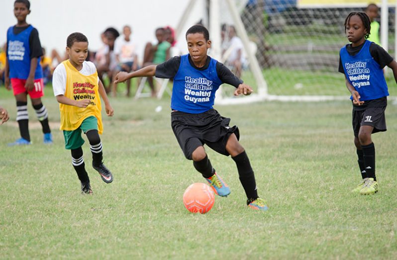 This Delano Williams photo captures this youngster as he focusses on the ball during the 2019 COURTS Pee Wee Football tournament.