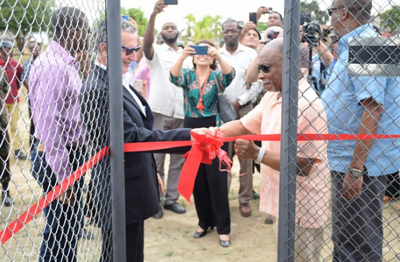Minister of Foreign Affairs Carl Greenidge (right) and Ambassador of Brazil to Guyana, Lineu Pupo de Paula cut the ribbon to officially hand over the wells to the communities