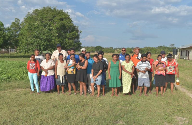 GWI personnel pose with residents of Katoka