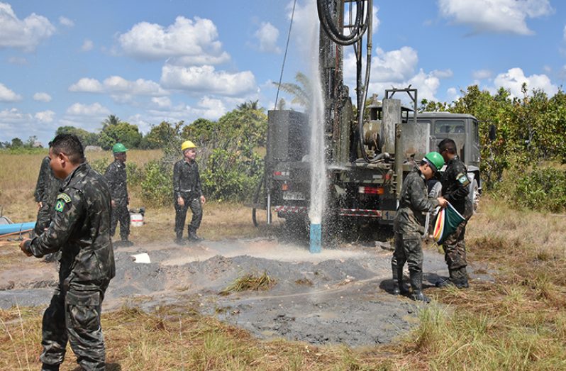 Members of the Brazilian army’s Sixth Battalion Engineering Corps celebrate as water spurts from a well that they dug in Chukrikednau Village (MoTP photo)