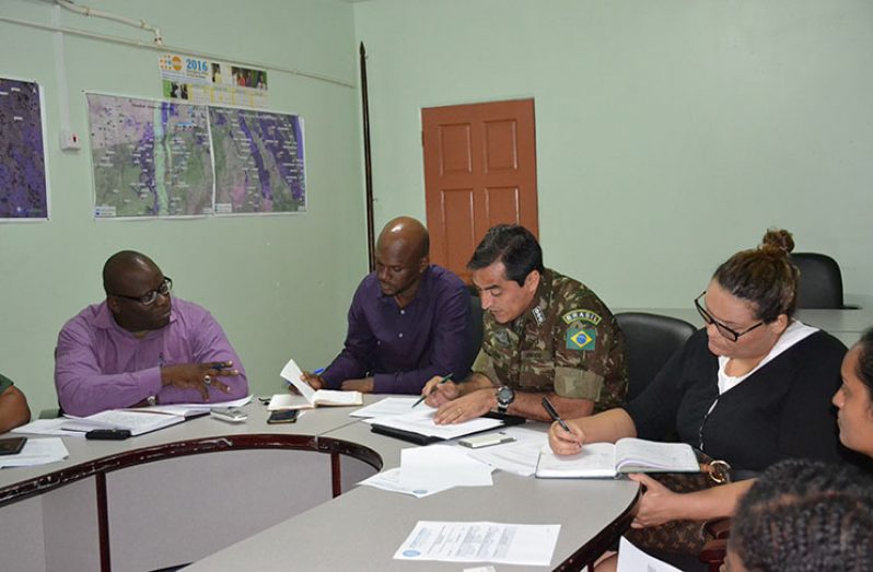 Brazilian Military Attaché to Guyana, Colonel Deni Da Silva and Acting Director-General of the Civil Defence Commission, Lieutenant-Colonel Kester Craig along with other stakeholders at the working- group meeting