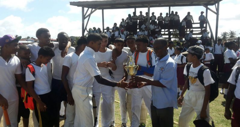 Javed Karim receives the winning trophy for his team from the West Berbice President, David Black.