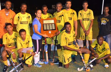 John Fernandes Insurance Limited representative Kerensa Fernandes (fourth (from right, standing) presents the winning trophy to Western Union Hikers team captain.