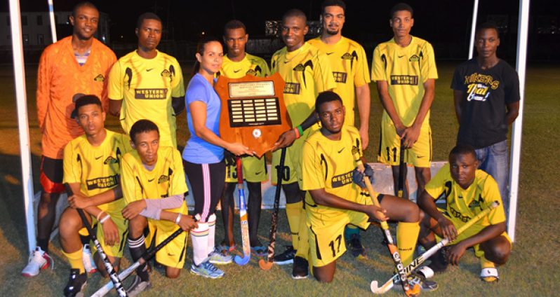 John Fernandes Insurance Limited representative Kerensa Fernandes (fourth (from right, standing) presents the winning trophy to Western Union Hikers team captain.