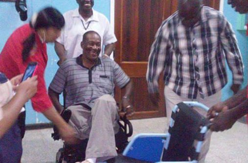 Happy in his new motorised wheelchair
