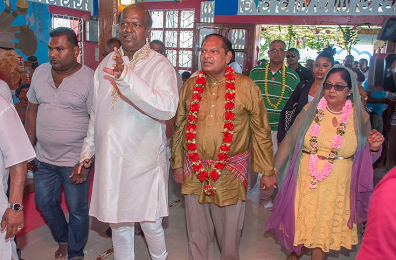 Prime Minister Moses Nagamootoo and Mrs Nagamootoo are taken on a tour of the temple by Head Priest, Harvey Hardeen (OPM photo)
