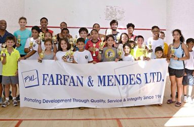 Prize winners of the Farfan and Mendes/Digicel Junior Christmas Squash Tournament strike a pose after receiving their trophies on Sunday at the Georgetown Club squash court.