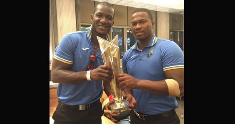 West Indies captain Darren Sammy and opener Johnson Charles with the World T20 trophy.