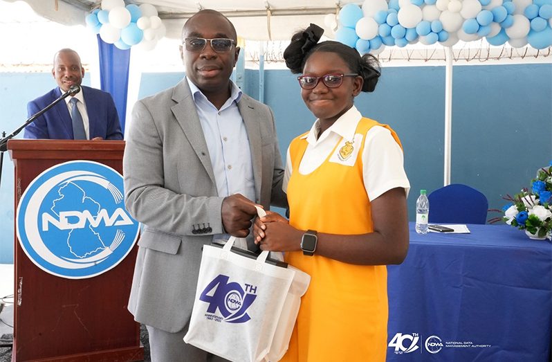 Minister within the Office of the Prime Minister, Kwame McCoy hands over the prizes to the winners of the WiFiGY Photo Contest (NDMA photos)