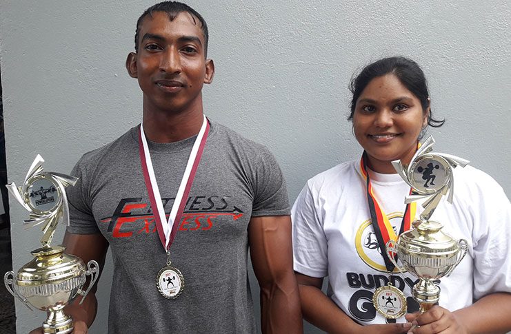 Male and Female overall winners Vijai Rahim and Lisa Oudit pose with their awards.