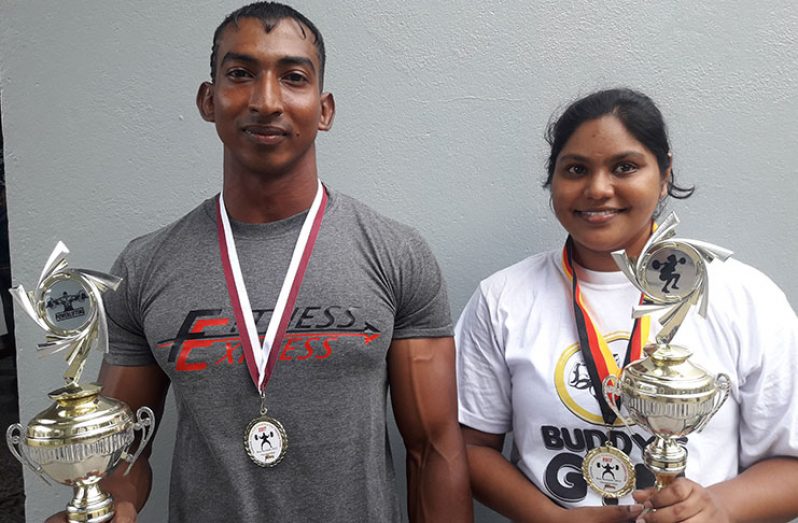 Male and Female overall winners Vijai Rahim and Lisa Oudit pose with their awards.